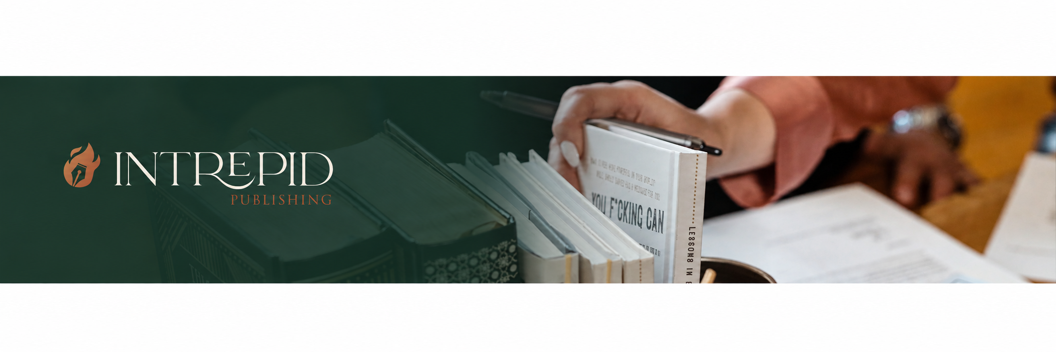 Intrepid Publishing banner with books and a hand holding a pen